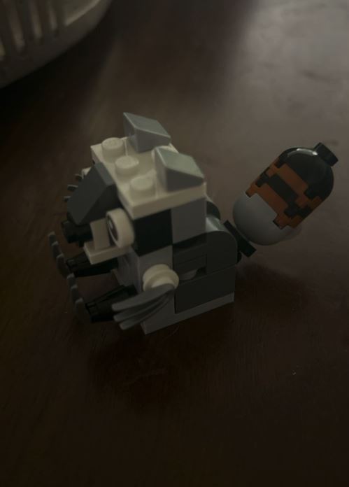 The same brick-built raccoon photographed from the side
